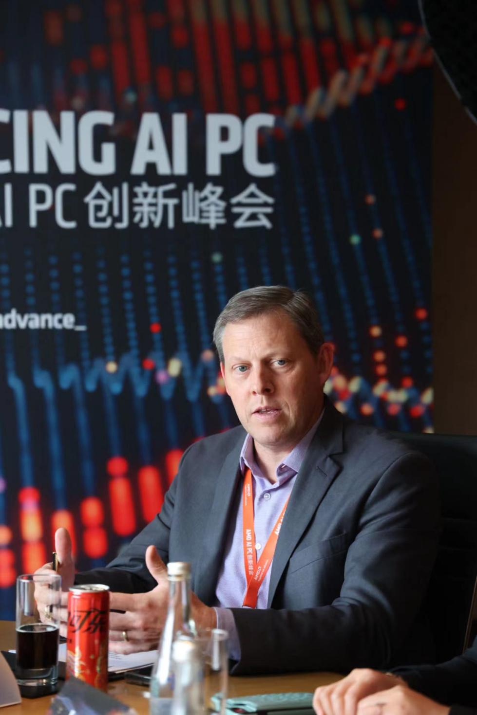 A person sitting at a table<br><br>Description automatically generated